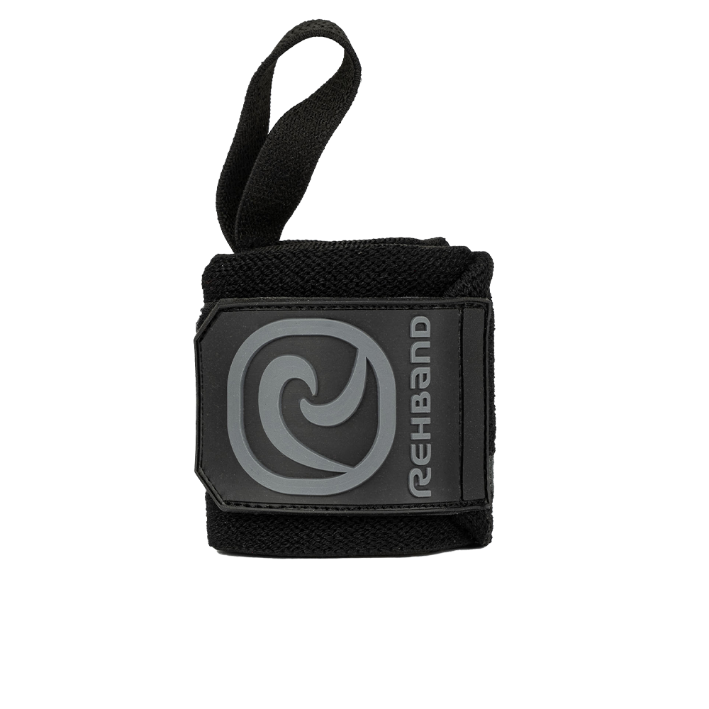 A black Rehband X-RX Wrist Wrap with a flat stitched thumb hook and logo on the strap.