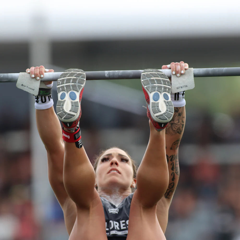 Person performing a pull-up with focus on grip and form using bear komplex straps