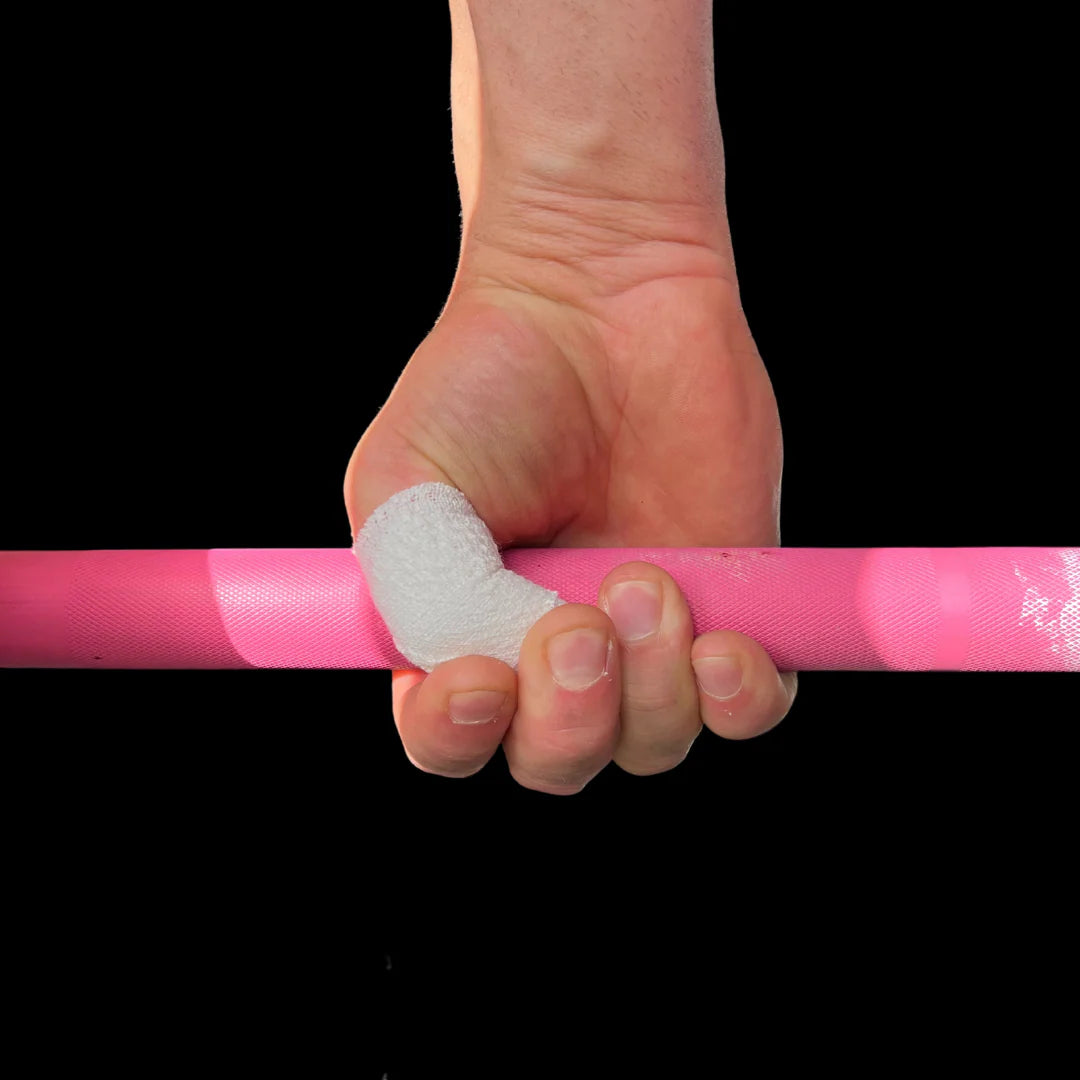 Hand holding a barbell with white frog grip thumb tape on a black background