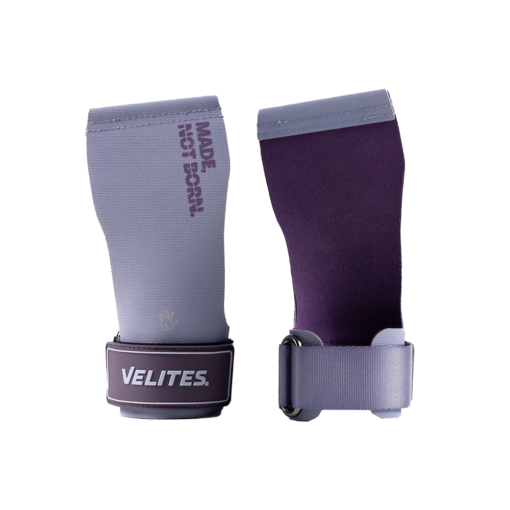 A pair of purple Velites gymnastic grips with wrist straps, displayed alongside a branded text 'NOT JUST GYMNASTICS'.