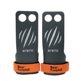 Pair of black and orange grip enhancers with 'Bear KompleX' branding on a white background