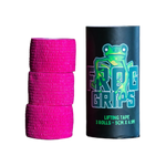 Pink lifting tape rolls with a black container labeled 'Frog Grips' on a dark surface.