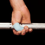 Hand holding a barbell with blue frog grip thumb tape on a black background