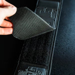 Black velcro patch being attached to a frog lifting belt