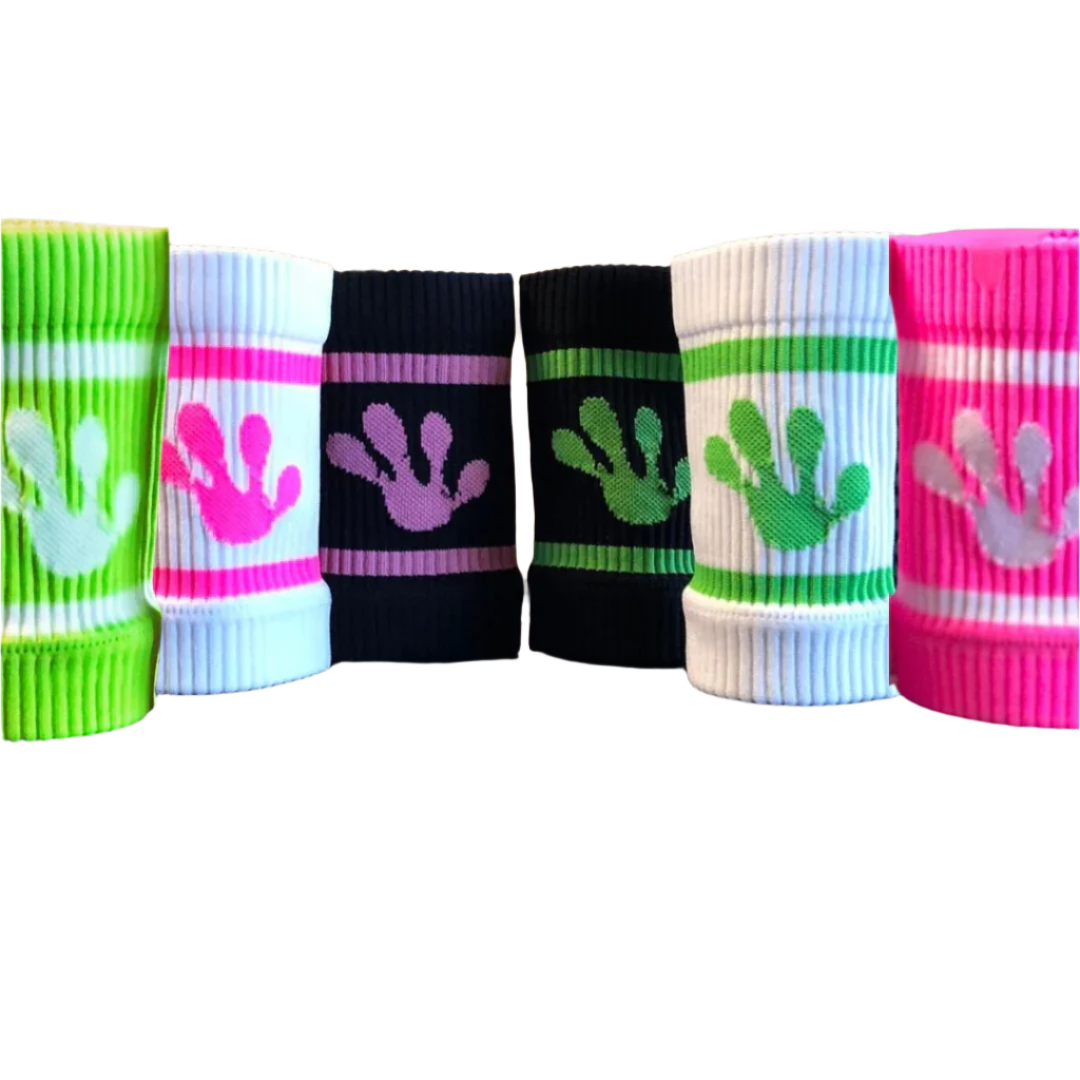 Colorful wrist bands by frog with hand print designs on a fitness equipment background