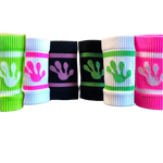 Colorful wrist bands by frog with hand print designs on a fitness equipment background