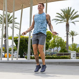 Man exercising with jump ropes outdoors on a sunny day