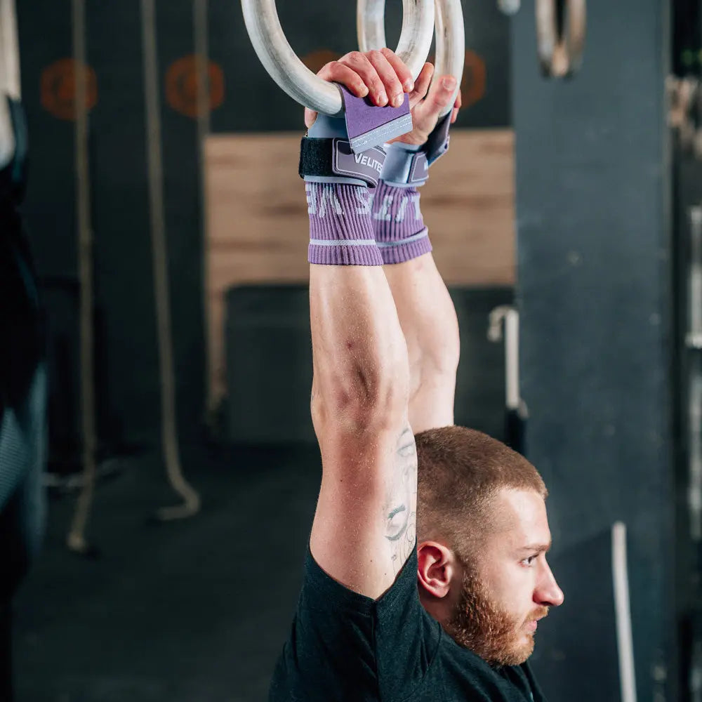 man using velites purple hand grips on gym rings