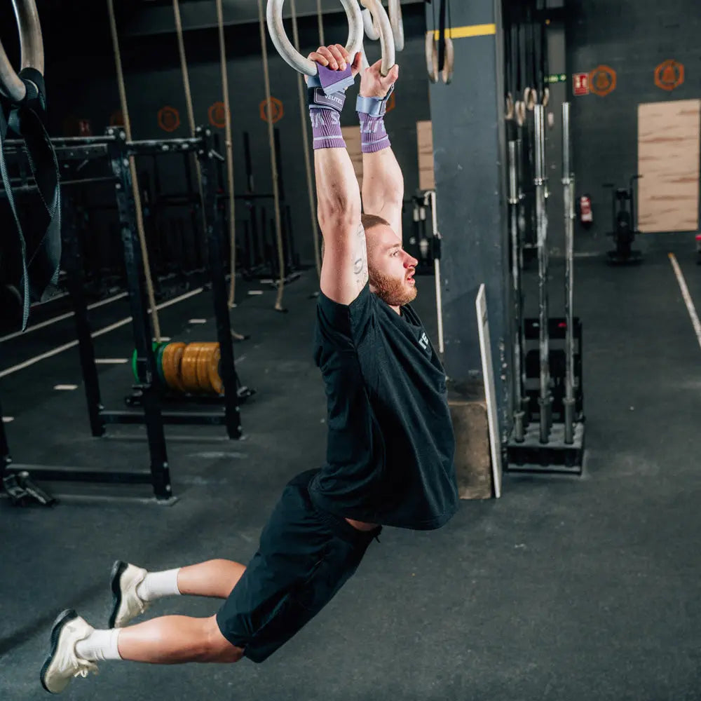 someone using gym equipment and purple velites hand grips