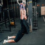 someone using gym equipment and purple velites hand grips