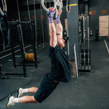 someone using gym equipment and purple velites hand grips