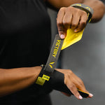Person holding a gymnastic grip with 'Victory' branding on a blurred background