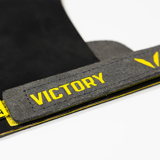 Gymnastic strap with yellow 'VICTORY' text on a white background