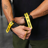 Person holding a hand grip with 'Victory' branding, wearing a black shirt and green pants.