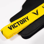 Black and yellow wrist wrap with 'Victory' branding on a white background
