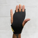 Black victory hand grip used for crossfit glove on a hand against a white background