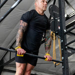 Person using victory hand grips in a gym setting