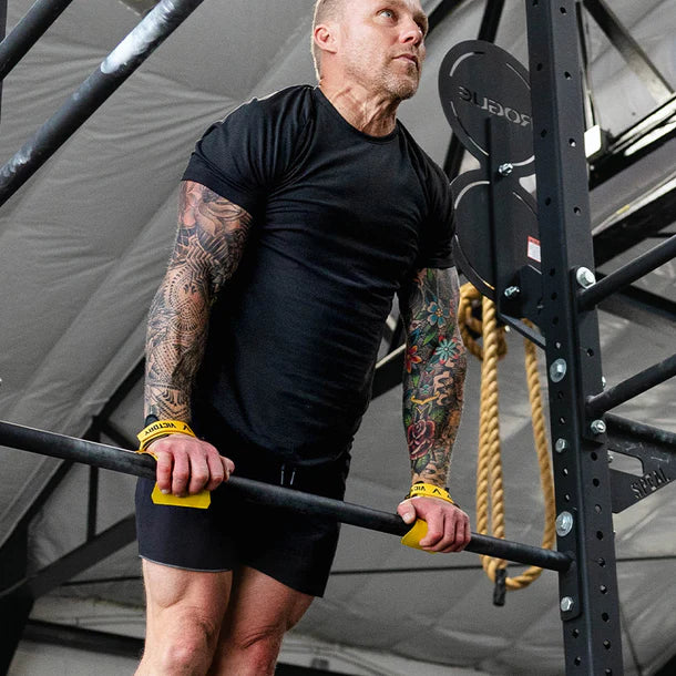 Person using victory hand grips in a gym setting