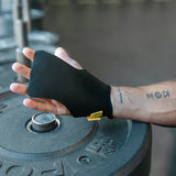 Person wearing a black wrist support on a gym weight plate