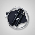 Black jump rope with metal clasps on a gray background