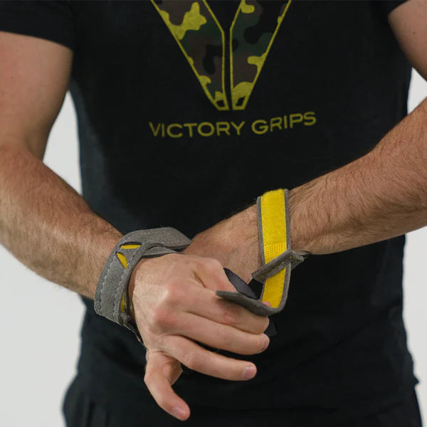CrossFit athlete putting on Victory Grips Tactical 3.0 Freedom grips